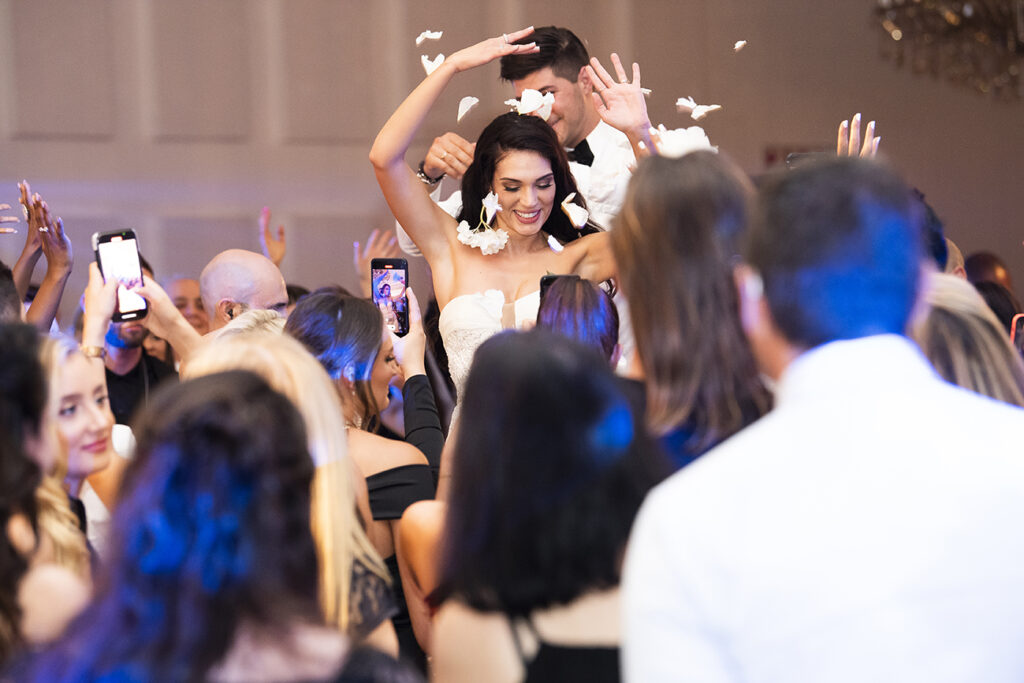 Candid moment for K&M wedding reception by Kevin Mark Pass Photography, bridal makeup by Storm Pass